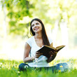 Photo: Woman reading book outdoors Woman reading book outdoors