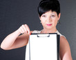 serious business woman with blank over dark background