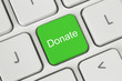 Green donate button on the keyboard close-up.