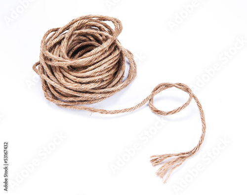 Photo: small rope coiled on white background small rope coiled on white background