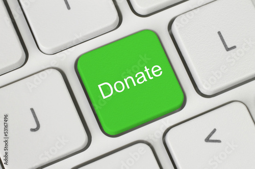 Photo: Green donate button on the keyboard close-up. Green donate button on the keyboard close-up.