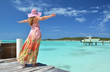 Girl on the wooden jetty looking to the ocean. Exuma, Bahamas