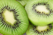 group of kiwi fruit slices covering a background