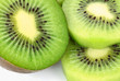 group of kiwi fruit slices covering a background