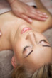 Beautiful young woman enjoys massage