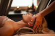 Beautiful young woman enjoys massage