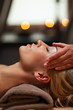 Beautiful young woman enjoys massage