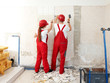 Photo: Young worker fixing up a house, work in a building lot Young worker fixing up a house, work in a building lot