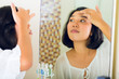 Photo: Asian woman discovering a pimple in face Asian woman discovering a pimple in face