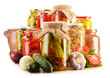 Foto: Composition with jars of pickled vegetables. Marinated food Composition with jars of pickled vegetables. Marinated food
