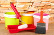 Paint pots, paintbrushes and coloured swatches