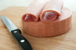 Sliced bologna sausage on cutting board