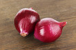 Purple onion on wooden background