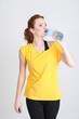Beautiful young woman with bottle of water