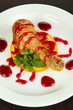 Small portion of food on big plate on wooden table