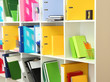 Foto: White office shelves with different stationery, close up White office shelves with different stationery, close up