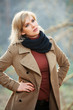 Foto: Happy blond woman in autumn forest Happy blond woman in autumn forest