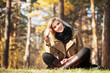 Photo: Happy blond woman in autumn forest Happy blond woman in autumn forest