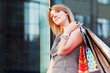 Photo: Happy young woman with shopping bags Happy young woman with shopping bags