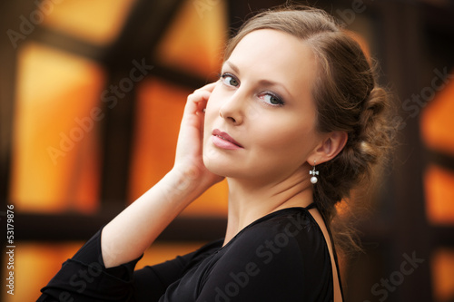Photo: Happy beautiful woman walking on the city street Happy beautiful woman walking on the city street