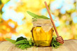 Jar of honey with flowers of lime,