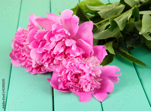 Photo: Beautiful peonies on table close-up Beautiful peonies on table close-up