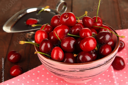 Photo: Ripe red cherry berries in bowl and chocolate sauce Ripe red cherry berries in bowl and chocolate sauce