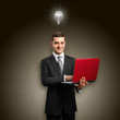 Photo: Idea Concept male in suit with laptop in his hands Idea Concept male in suit with laptop in his hands