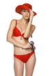 Photo: Woman in red bikini wearing straw hat and holding sunglasses Woman in red bikini wearing straw hat and holding sunglasses