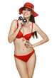 Photo: Smiling woman in red bikini wearing straw hat holding sunglasses Smiling woman in red bikini wearing straw hat holding sunglasses