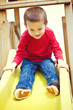 Boy sliding on playground