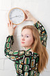 Young woman and clock