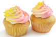 Foto: Two pink and yellow cupcake, isolated on white background Two pink and yellow cupcake, isolated on white background