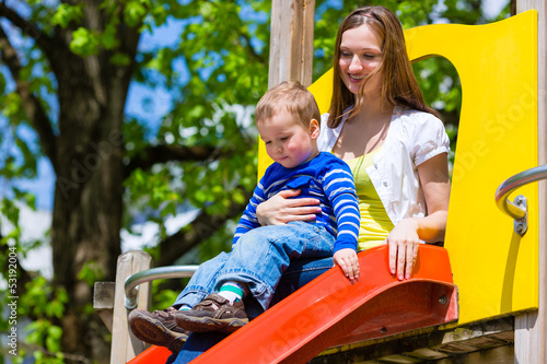 Photo: Family - Mother and son playing on a jungle gym Family - Mother and son playing on a jungle gym
