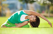 Photo: Pretty woman doing yoga exercises in the park Pretty woman doing yoga exercises in the park