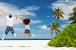 Photo: Happy couple jumping on the tropical beach Happy couple jumping on the tropical beach