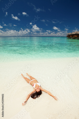 Photo: Cute woman relaxing on the tropical beach Cute woman relaxing on the tropical beach