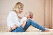 mother playing with baby boy indoors