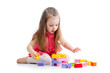 Photo: child girl playing with construction set over white background child girl playing with construction set over white background