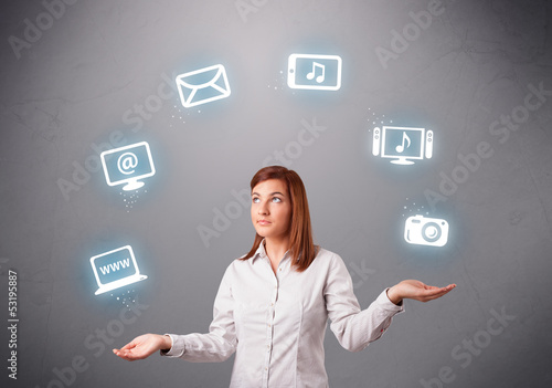 Photo: pretty girl juggling with elecrtonic devices icons pretty girl juggling with elecrtonic devices icons