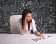 Photo: Businesswoman sitting at desk with business scheme and icons Businesswoman sitting at desk with business scheme and icons