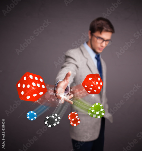 Photo: Attractive man throwing dices and chips Attractive man throwing dices and chips