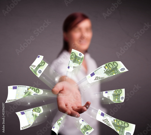 Photo: Pretty woman standing and throwing money Pretty woman standing and throwing money