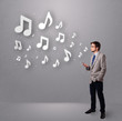 attractive young man singing and listening to music with musical