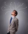 Photo: Young man thinking with arrows overhead Young man thinking with arrows overhead