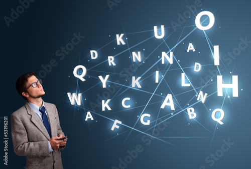 Photo: Young man typing on smartphone with high tech 3d letters comming Young man typing on smartphone with high tech 3d letters comming