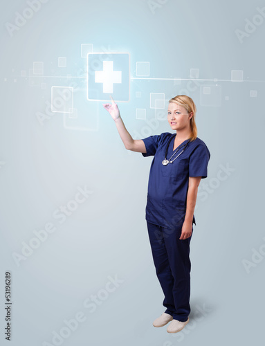 Photo: Young nurse pressing modern medical type of buttons Young nurse pressing modern medical type of buttons