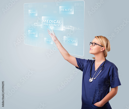 Photo: Young nurse pressing modern medical type of buttons Young nurse pressing modern medical type of buttons