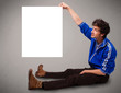 Young boy presenting white paper copy space