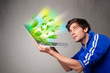 Photo: Casual boy holding laptop with recycle and environmental symbols Casual boy holding laptop with recycle and environmental symbols